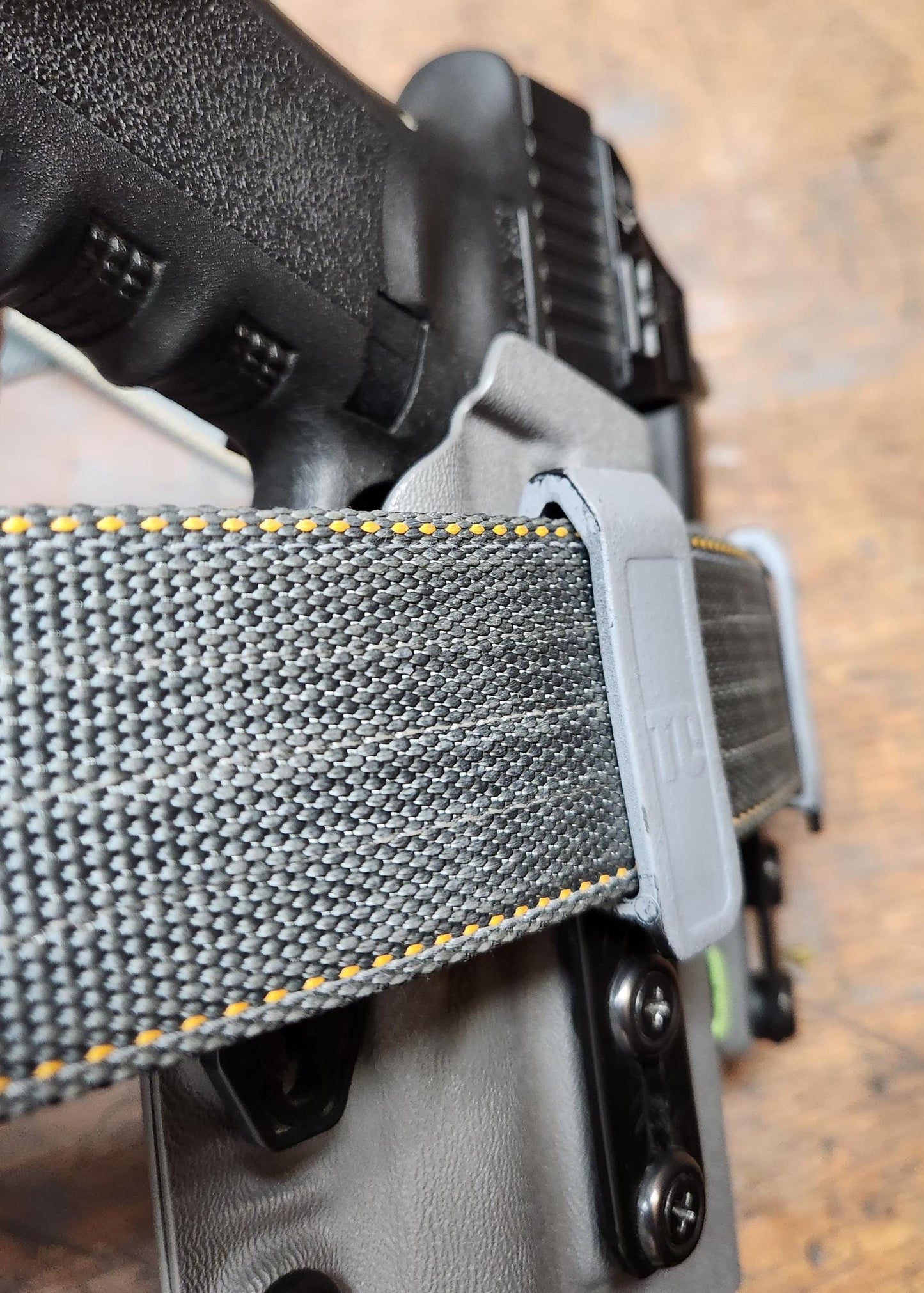 Closeup of gray Advanced CCW belt for appendix carry with holster.